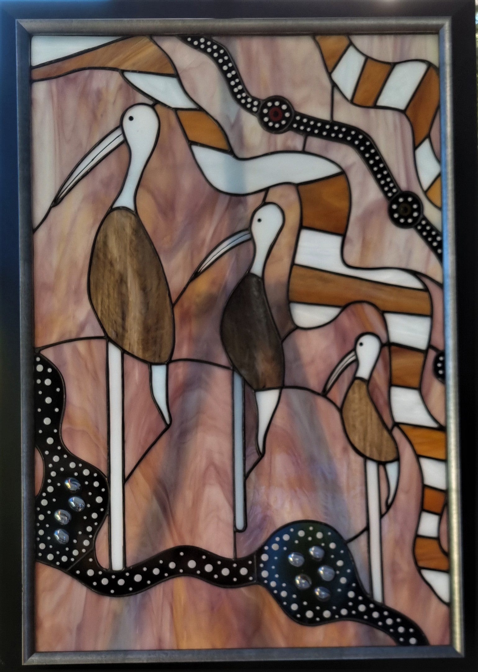 Brolga's life depicts the brolga who journeyed across the landscape, mountain peaks, sky's and waterways to eventually reunite in a place of abundance and reflection.   * Please note tripod stand centrally appearing in photo, not part of the Glass Art piece. 